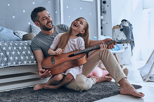 dad and daughter playing in room